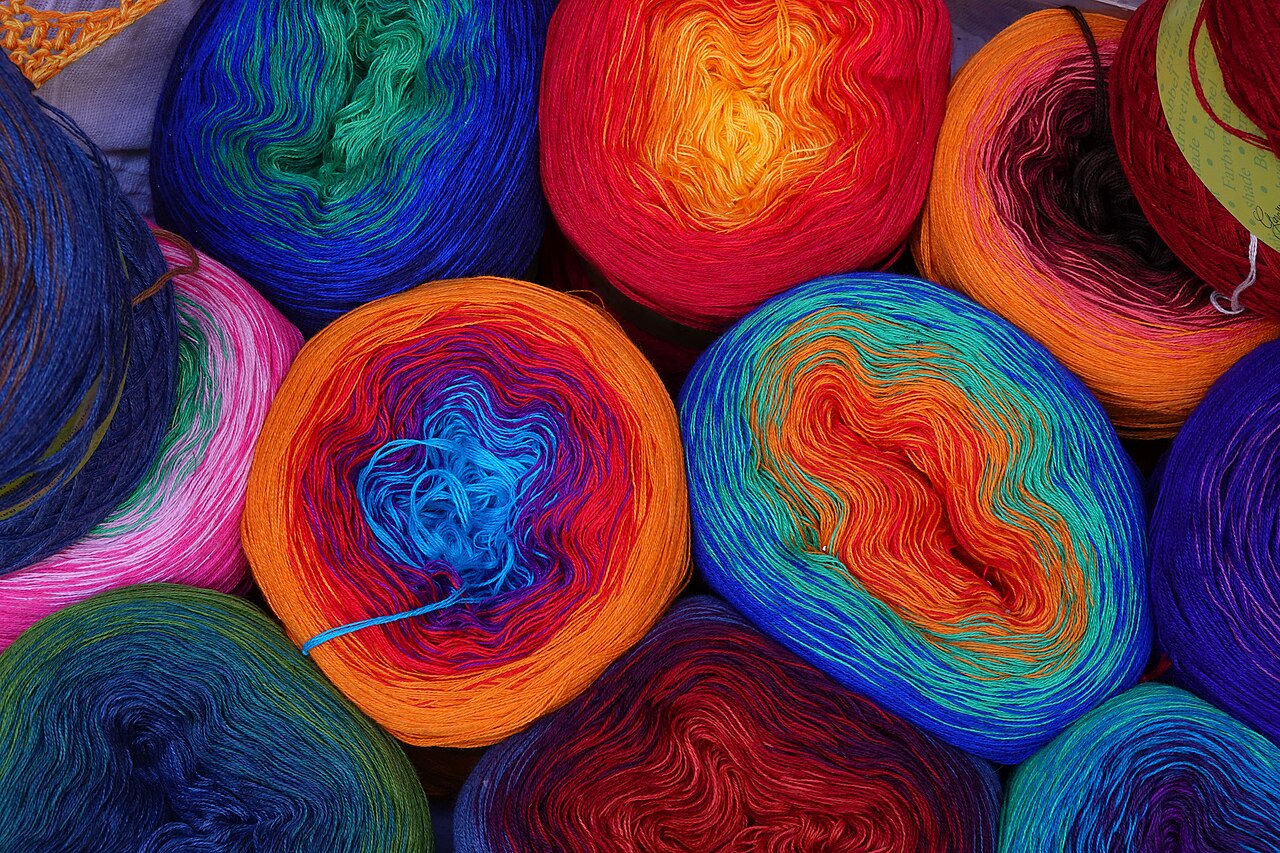 A top-down view of multicoloured yarn balls