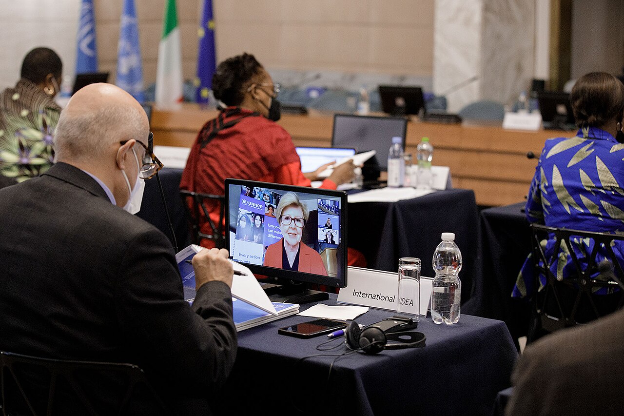 People at a formal meeting with digital displays