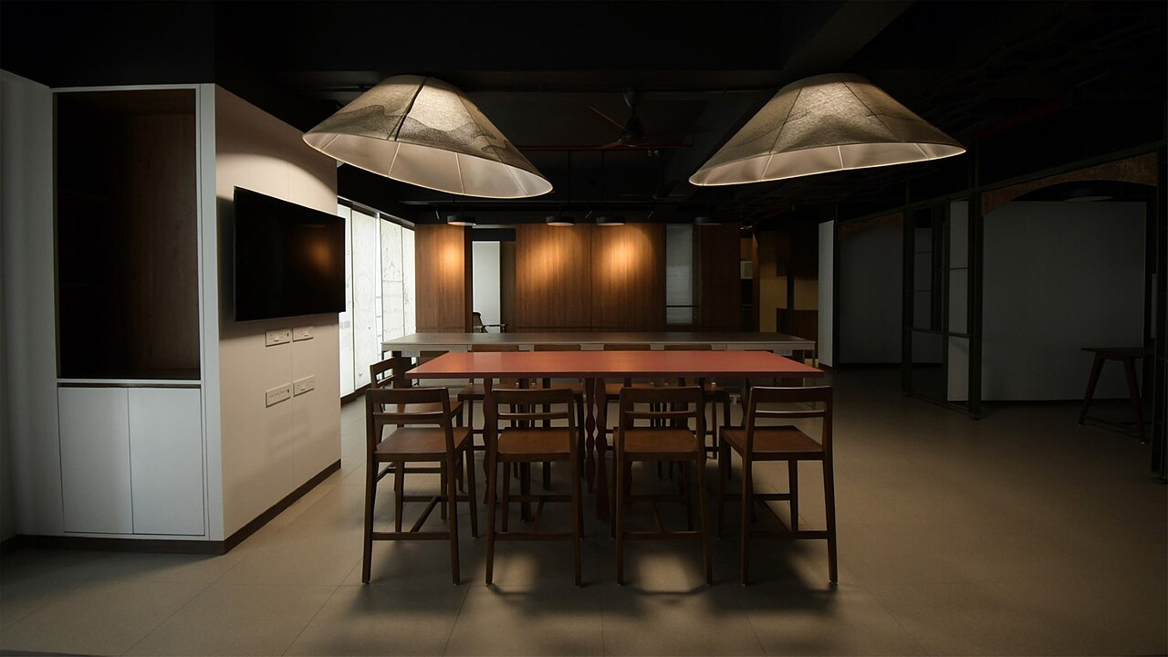 A modern conference room with a long wooden table