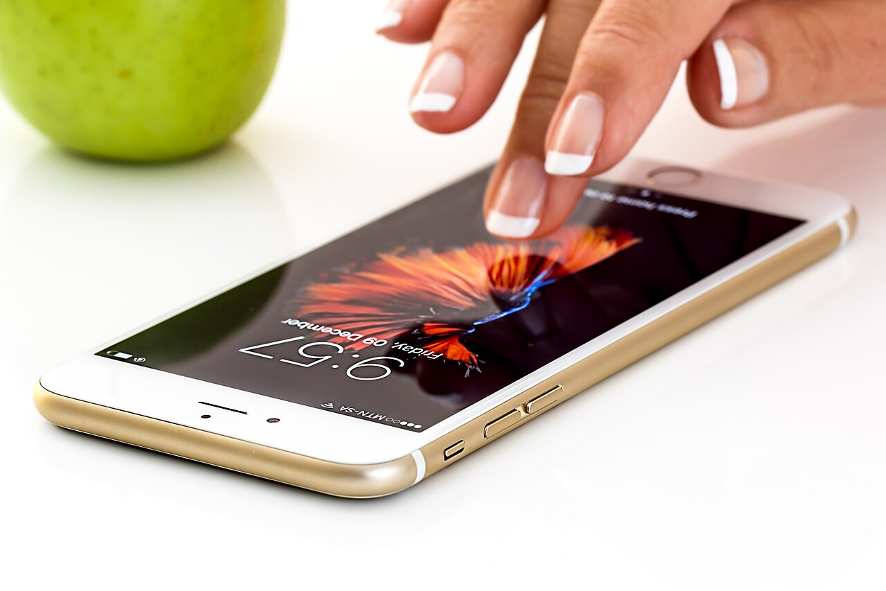 A finger touching a smartphone screen
