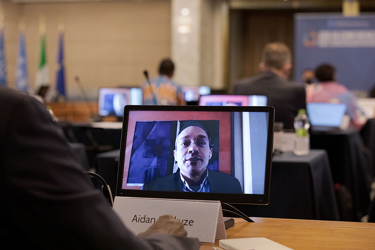 Over-the-shoulder view of a man in a video conference