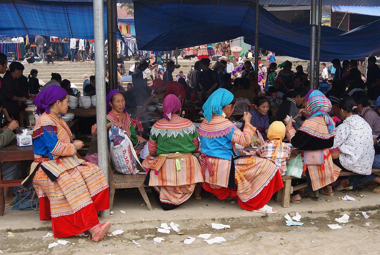 Women in colourful clothing at an outdoor market