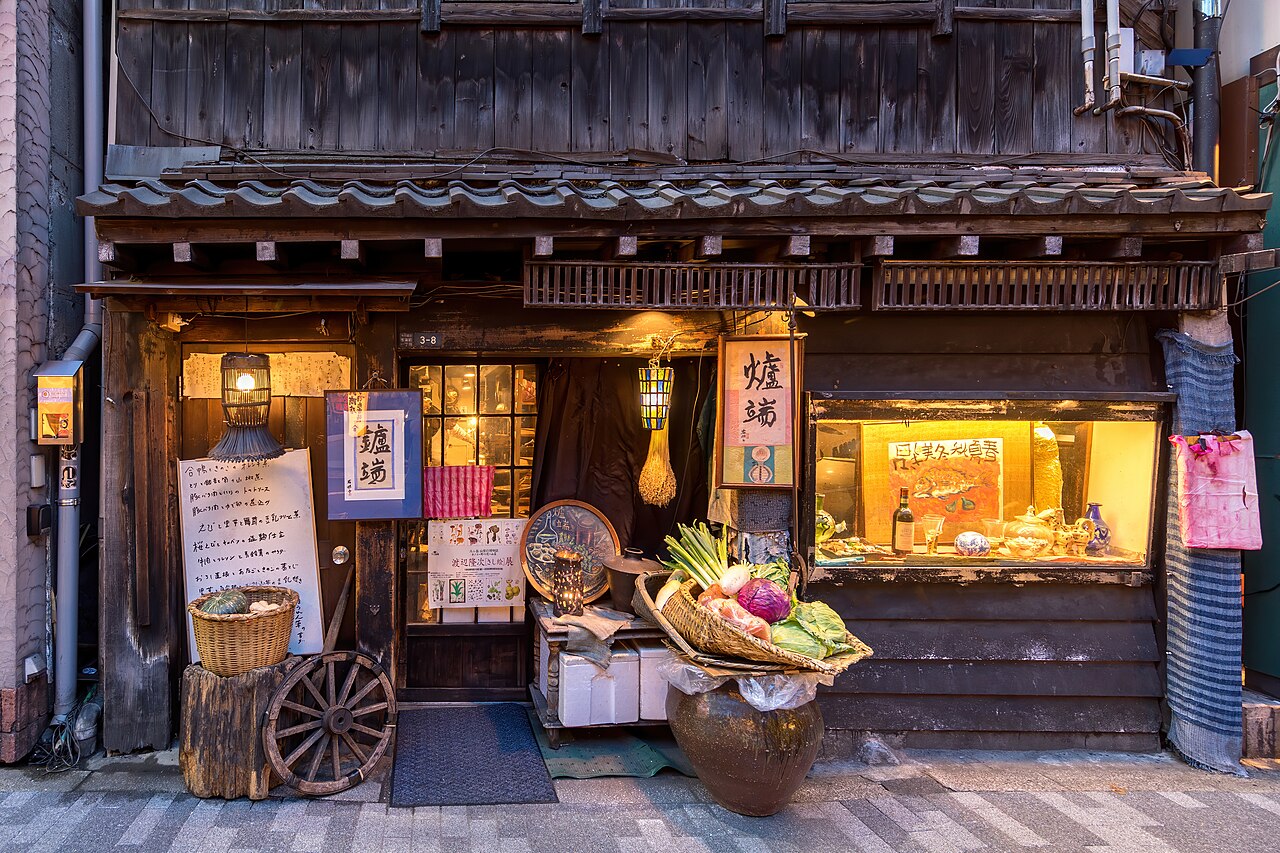 A warmly lit shop front at night