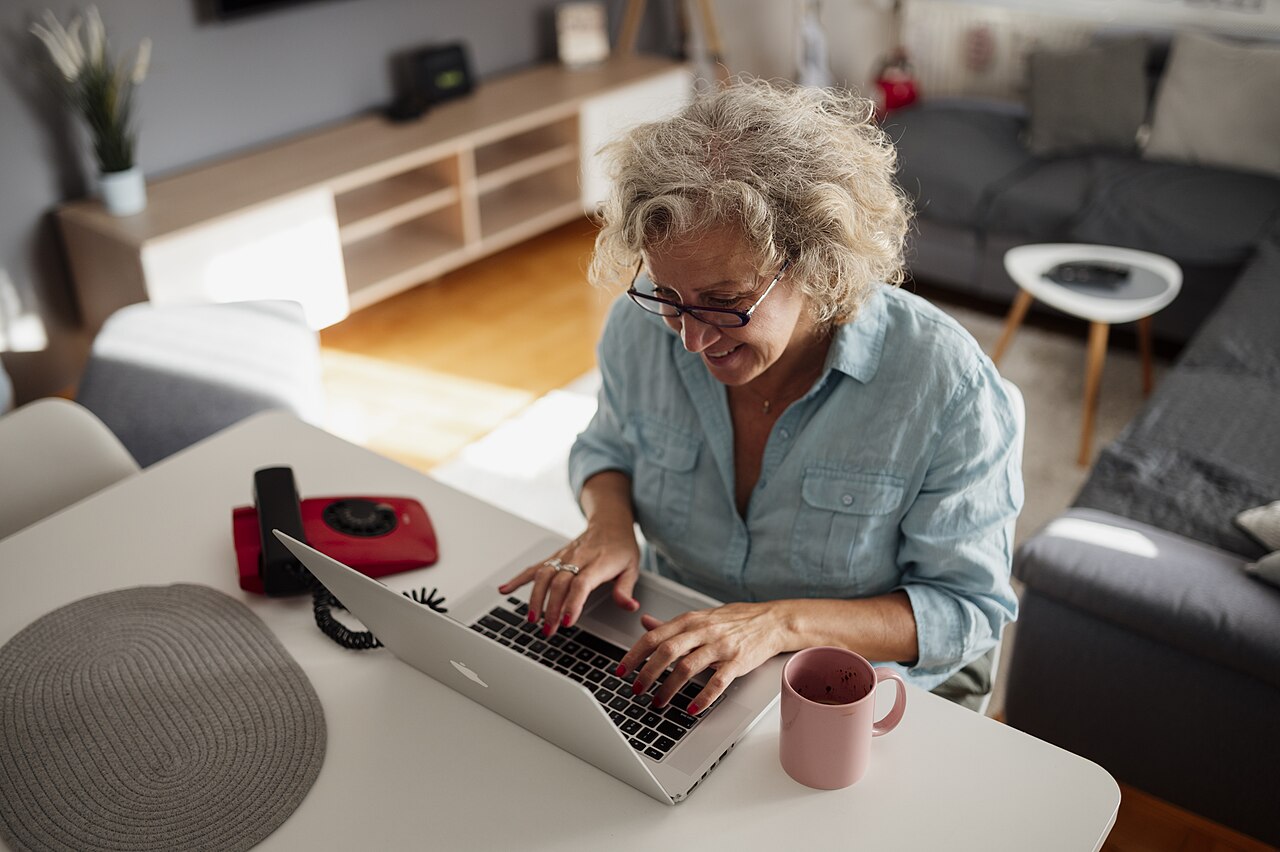 A woman using a laptop in a living room