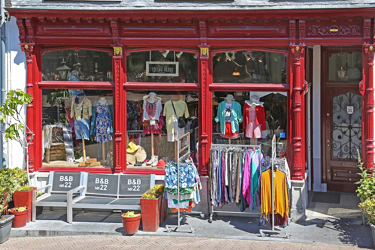A red storefront with clothing in the windows