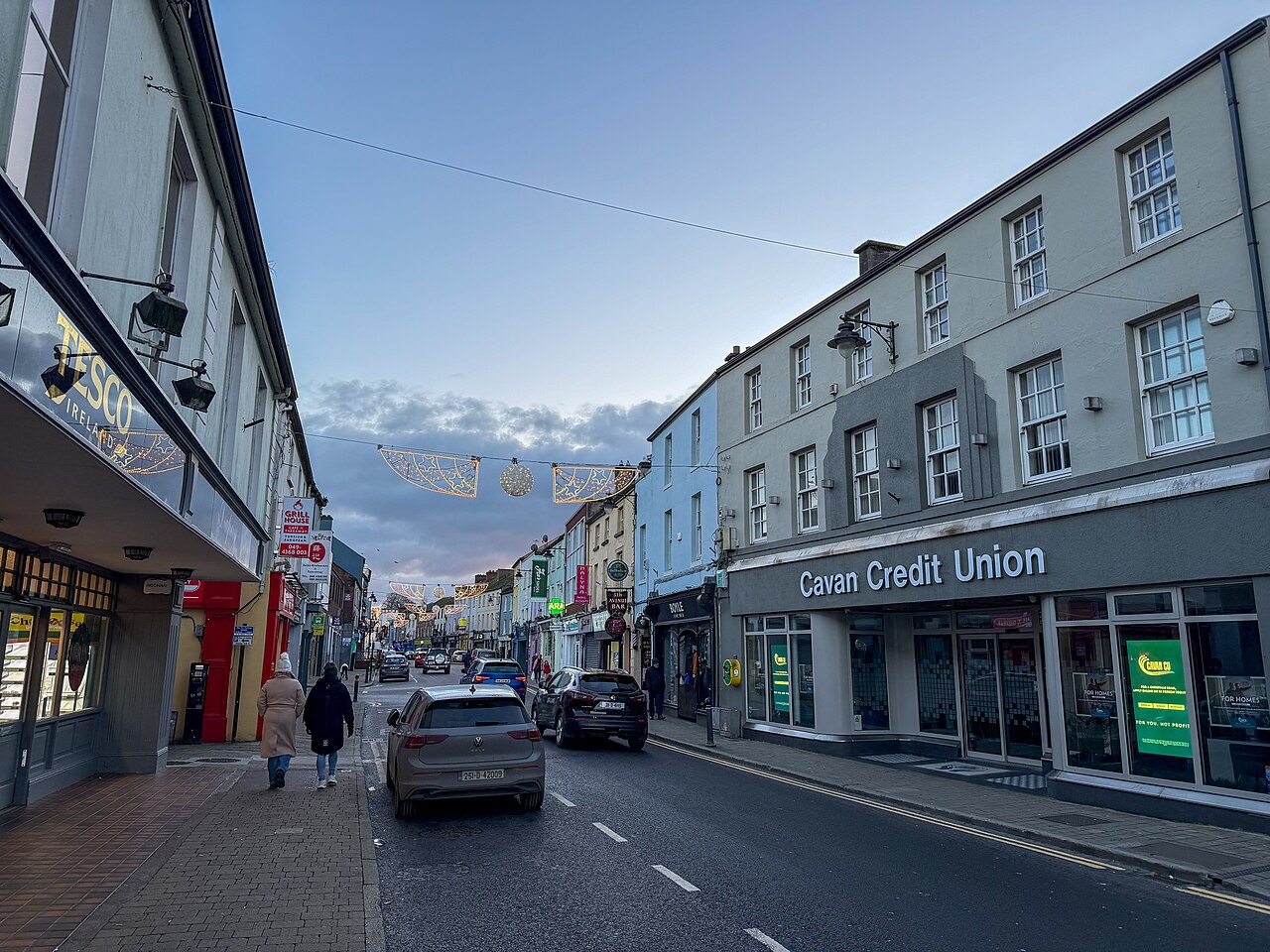 A town street with shops and parked cars