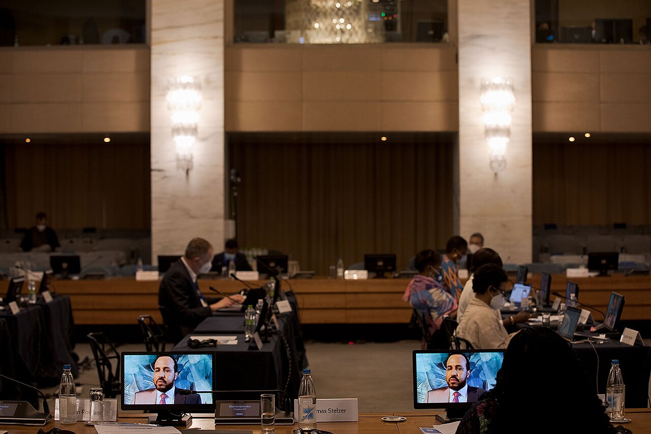 A conference room with video screens along the wall