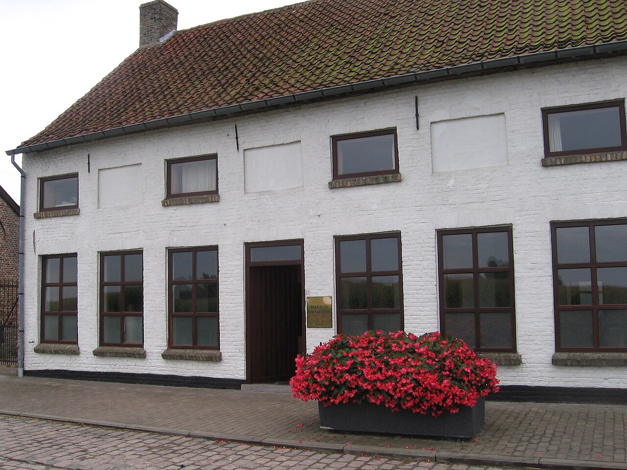 A white brick building with dark windows