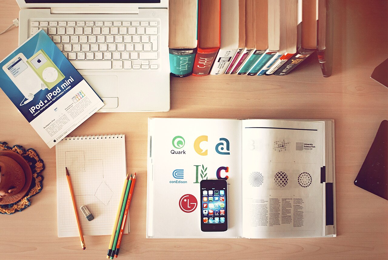Top-down view of a creative workspace with books and a phone