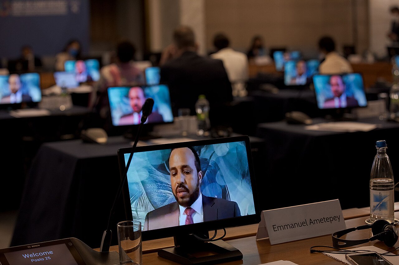 Monitors in a conference hall showing a video call