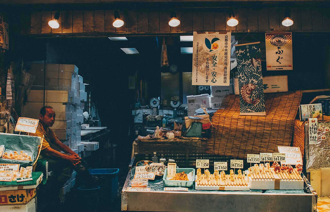 A market stall at night with goods on display