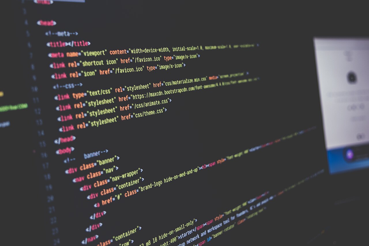 Close-up of colourful code on a dark screen